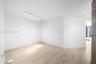 Interior space featuring light wood-finish flooring, recessed lighting, and adjustable track lighting