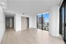 Floor-to-ceiling windows, wood-finish flooring, recessed lighting, and built-in closet with sliding doors