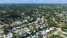 Aerial perspective of the waterfront property featuring direct canal access and residential street positioning