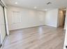Interior space featuring wood-finish flooring, recessed lighting, sliding glass door, and louvered-style closet doors