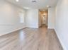 Interior space featuring wood-finish flooring, recessed lighting, and a window with vertical blinds