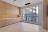 Built-in light-tone wood cabinetry with integrated storage, fluted wood detailing, smooth-surface countertops, and large picture windows