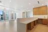 Open-concept interior featuring light-toned wood-finish flooring, recessed lighting, and expansive windows