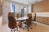 Built-in wood-finish cabinetry with stone-surface countertop, floor-to-ceiling windows, and recessed ceiling lighting