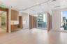 Built-in light-tone wood cabinetry, recessed ceiling lighting, light wood-finish flooring, floor-to-ceiling windows, and wall-mounted privacy tracking