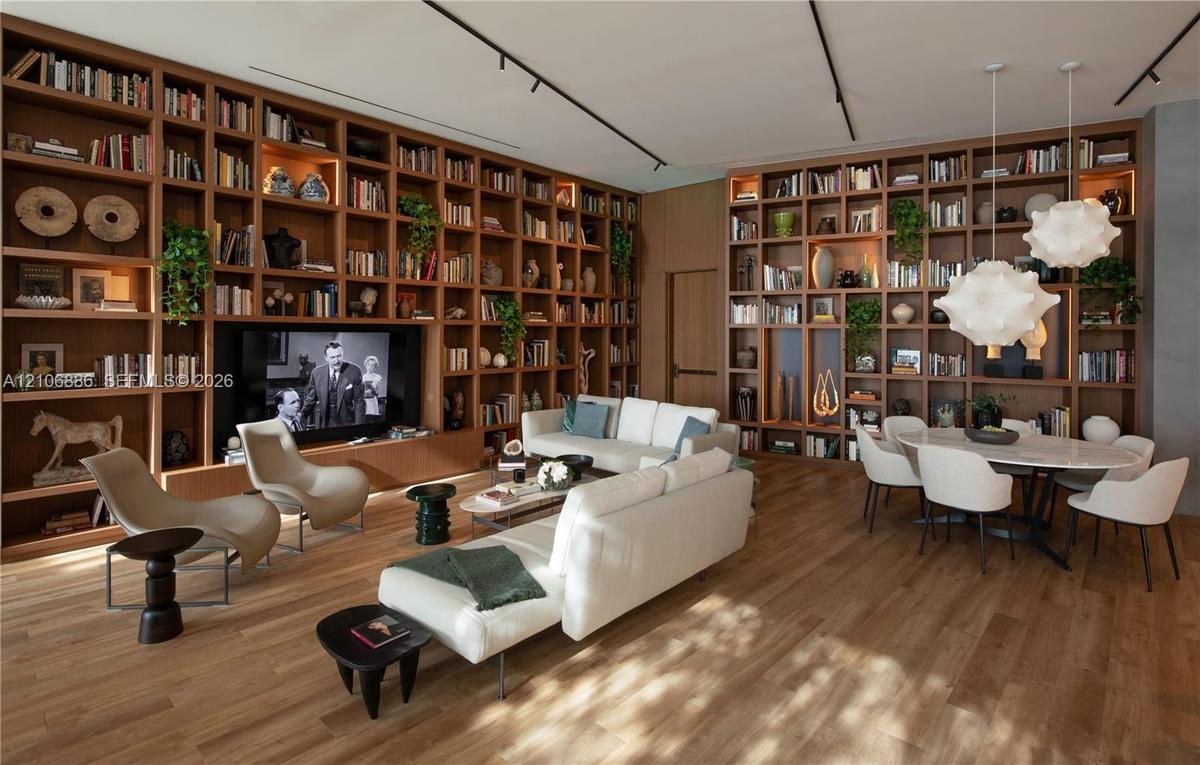 Floor-to-ceiling custom wood-finish built-in cabinetry, integrated linear ceiling lighting, and wood-finish flooring