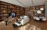 Floor-to-ceiling custom wood-finish built-in cabinetry, integrated linear ceiling lighting, and wood-finish flooring