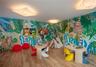 Interior room featuring wood-finish flooring, full-wall mural detailing, and recessed angular lighting fixtures