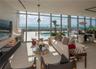 Floor-to-ceiling glass walls, expansive terrace, private swimming pool, neutral stone-finish tile flooring, and integrated ceiling lighting