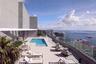 High-rise terrace featuring a rectangular swimming pool, tile flooring, and a glass-paneled perimeter railing