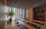 Wood-finish flooring, floor-to-ceiling windows with integrated horizontal slat screening, and wall-to-wall wood-paneling featuring recessed ceiling tr