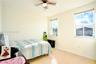 Room featuring light-tone wood-finish flooring, dual windows with blinds, and a ceiling fan with integrated lighting
