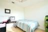 Neutral wall palette with wood-finish flooring and a ceiling-mounted light fixture