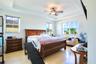 Tray ceiling, ceiling fan with integrated light fixture, and wood-finish flooring