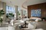 Floor-to-ceiling glass walls, curved architectural detailing, smooth stone flooring, and expansive wood-paneled accent walls