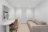 Interior space featuring recessed lighting, wood-finish flooring, two solid-core interior doors, and a central louvered-panel door with brushed nickel