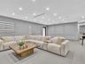 Interior space featuring recessed lighting, large-format tile flooring, wall molding detail, and dual-layered window shades