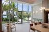 Floor-to-ceiling windows, light-toned terrazzo flooring, recessed lighting, and modern wall-mounted light fixtures