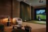 Integrated golf simulator room featuring wood-paneled walls, floor-to-ceiling drapery, recessed lighting, and a specialized athletic flooring surface