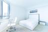 Floor-to-ceiling windows with expansive city exposure, wall-to-wall carpeting, and neutral interior finishes