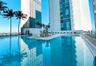 Outdoor swimming pool featuring a central island with abstract sculpture, tile surround, and metal railings