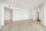 Open interior featuring stone tile flooring, crown molding, and recessed lighting