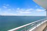 Private balcony featuring white metal railings and expansive water scenery