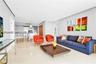 Open-concept interior featuring light-toned stone-finish flooring, recessed lighting, and smooth-finish walls