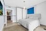 Built-in floor-to-ceiling white cabinetry, smooth-finish stone flooring, recessed ceiling lighting, and a cylindrical pendant light fixture