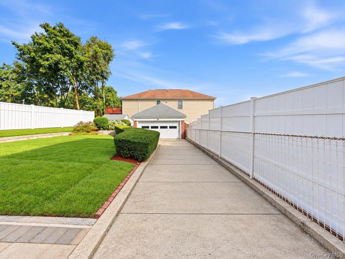Right Side of the House(Long Driveway with aDetached 2 Car Garage)