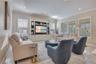 Bright family room with multiple windows and an open layout offers comfortable space for relaxing and entertaining.