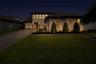 Twilight front view showcases the home’s welcoming entrance and landscape lighting.