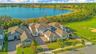 Lake views framed by mature trees and natural landscaping along the backyard.