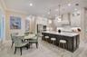 Spacious kitchen and breakfast area featuring upgraded tile flooring, crown molding and recessed lighting.