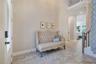 Bright foyer with soaring ceilings and upgraded tile flooring creates an inviting first impression.