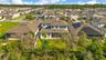 Rear aerial view highlights the spacious backyard, covered lanai and mature trees.