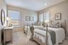 Comfortable bedroom featuring plush carpet, recessed lighting and plantation shutters.
