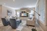 Inviting family room featuring crown molding, recessed lighting and plantation shutters.