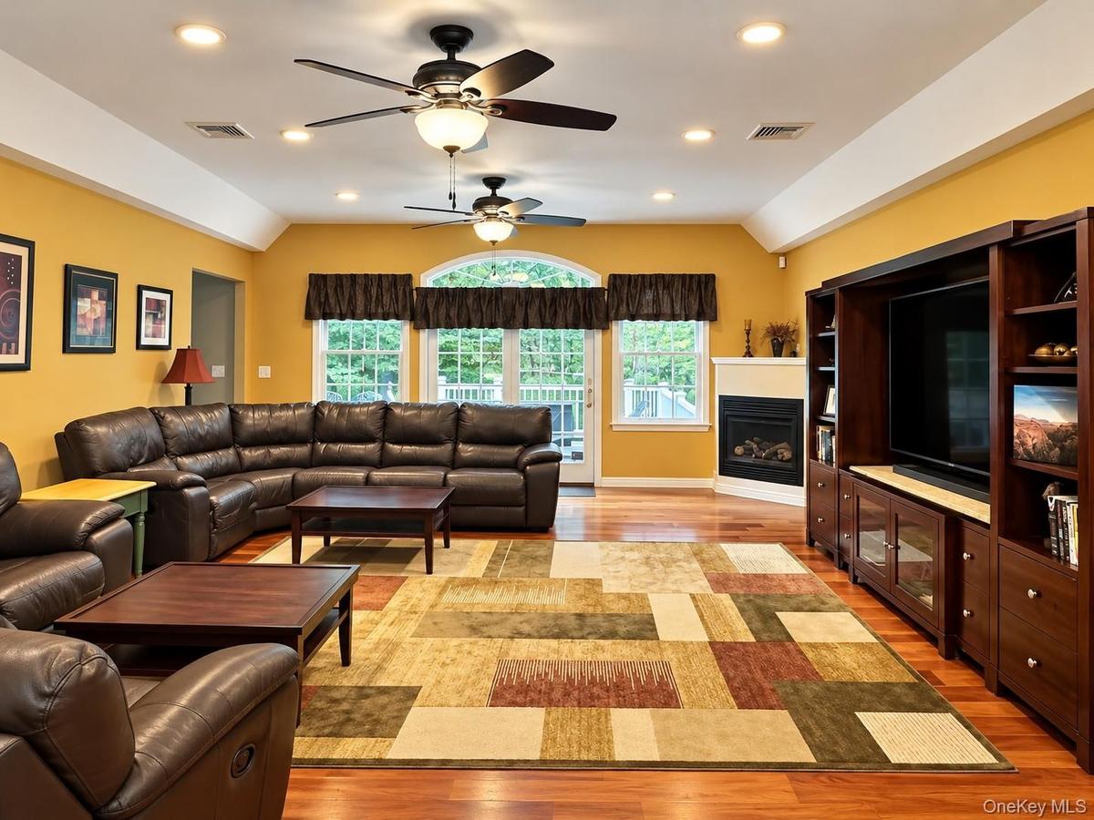 Family Room with wood floors, recessed lighting propane fireplace -