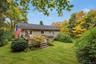 Back of home with attached deck and private yard