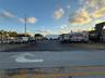 Paved open-air lot featuring a chain-link perimeter fence and gated access