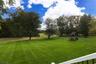 Manicured lawn, overlooks woo
