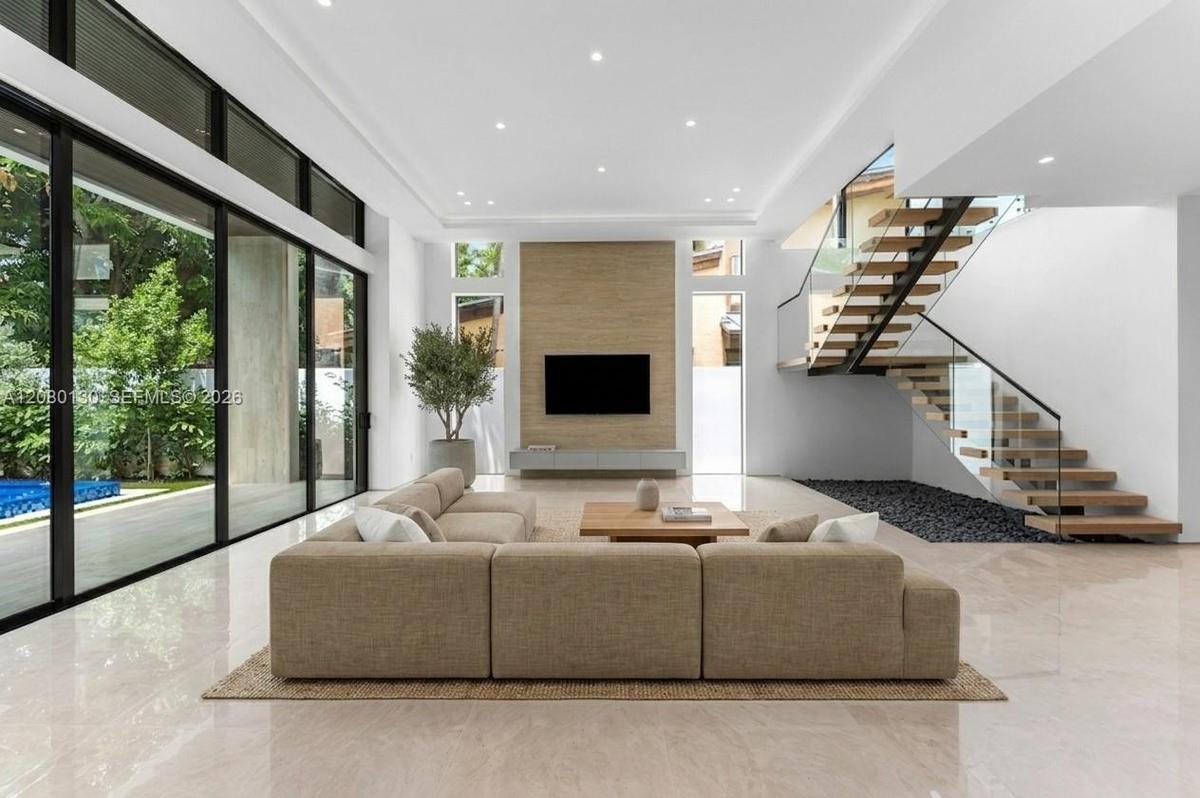 Living Room. Disclaimer: Several photographs presented in this listing contain digitally added furniture, artwork, and decor. These virtually staged i