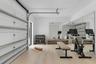 Garage/Gym. Disclaimer: Several photographs presented in this listing contain digitally added furniture, artwork, and decor. These virtually staged im