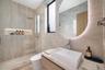 Guest Bathroom. Disclaimer: Several photographs presented in this listing contain digitally added furniture, artwork, and decor. These virtually stage