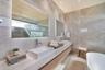 Primary Bathroom. Disclaimer: Several photographs presented in this listing contain digitally added furniture, artwork, and decor. These virtually sta