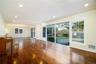View of great room facing dining area and covered screened porch. Photos taken when house was empty prior to occupancy.