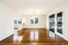 Spacious dining area with detailed oak. Photos taken when house was empty prior to occupancy. floors, access to kitchen and covered screened porch