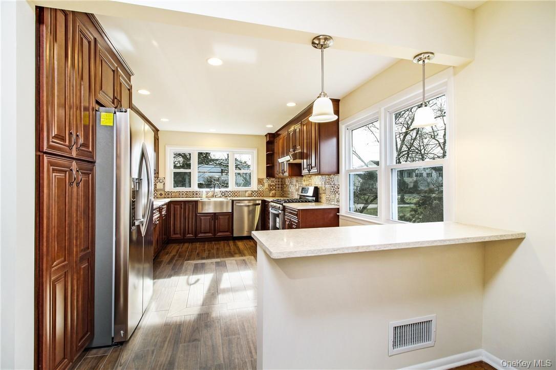 Eat-in-kitchen and breakfast bar. Photos taken when house was empty prior to occupancy.