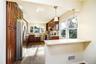 Eat-in-kitchen and breakfast bar. Photos taken when house was empty prior to occupancy.